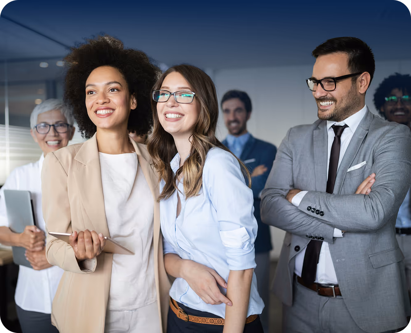 A group of people smiling together in an office.